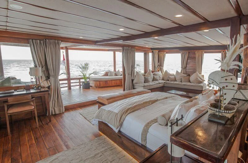 a large bedroom with a large bed aboard PRANA Yacht for Charter