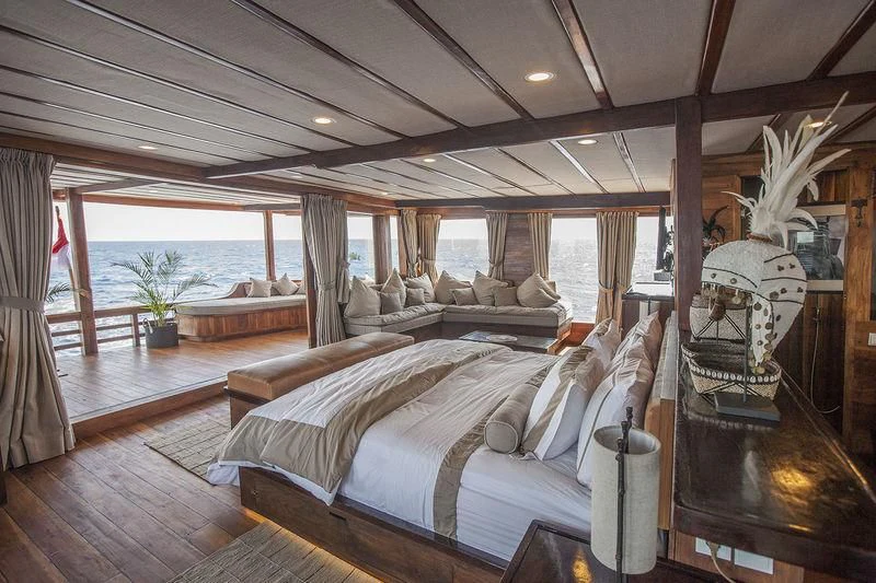a large bedroom with a large bed aboard PRANA Yacht for Charter