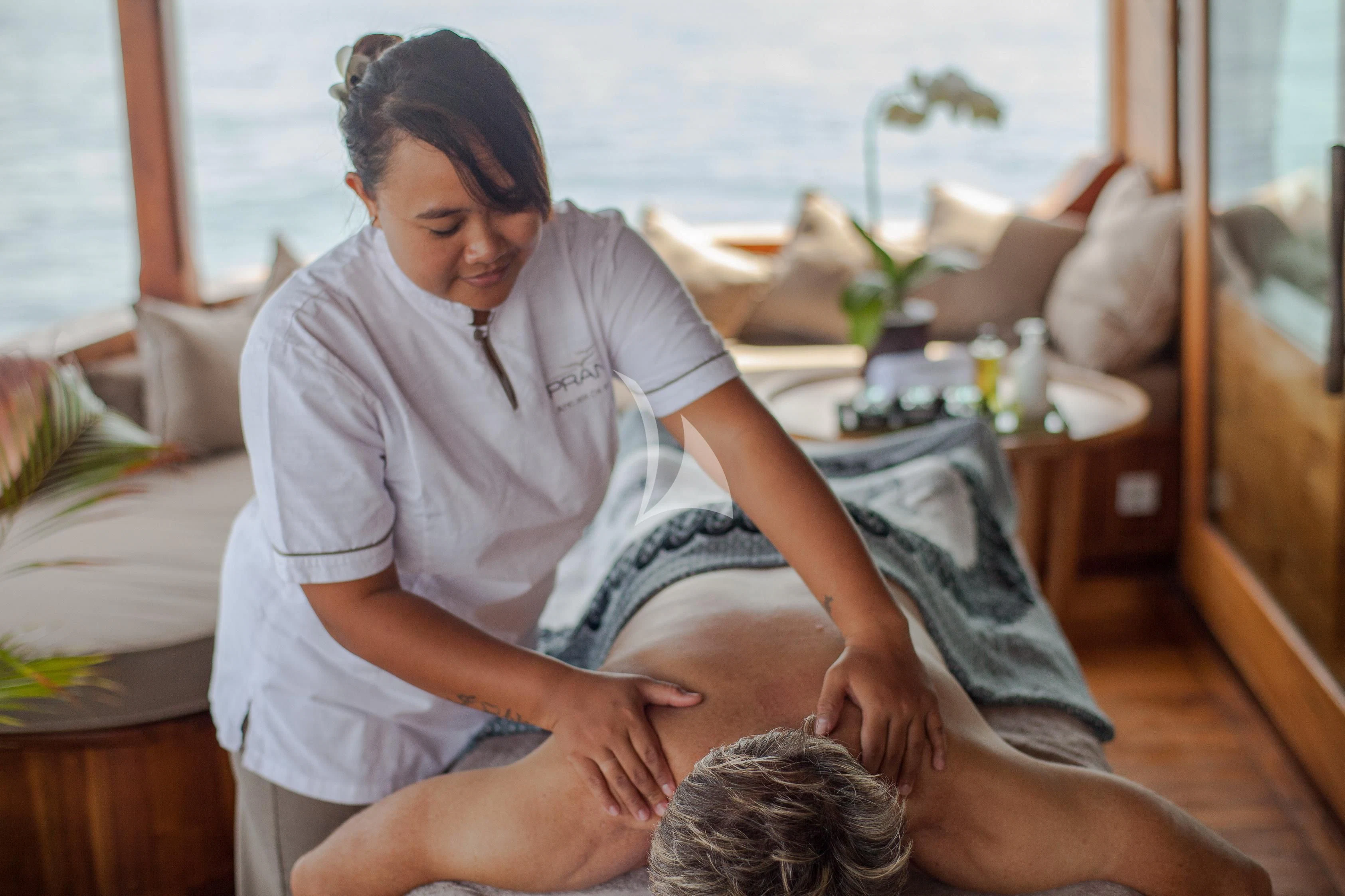 a person holding a baby aboard PRANA Yacht for Charter