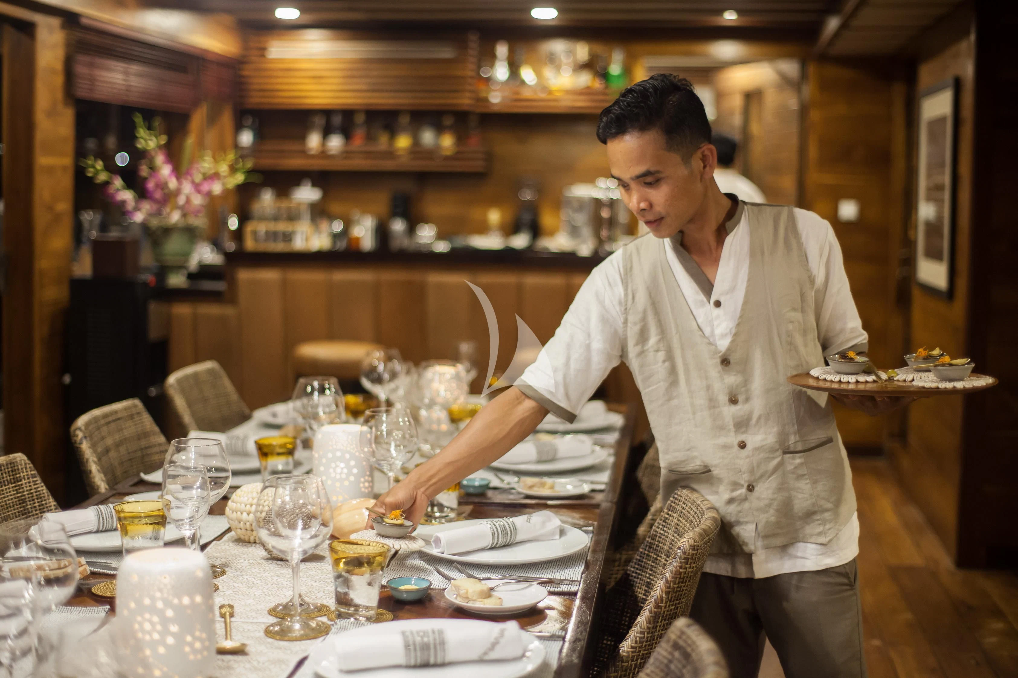 a person sitting at a table aboard PRANA Yacht for Charter