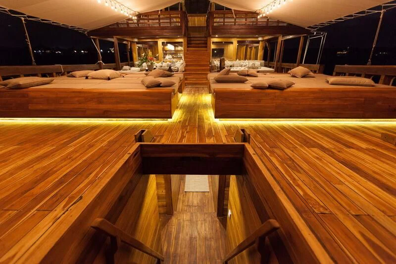 a room with wooden furniture aboard PRANA Yacht for Charter