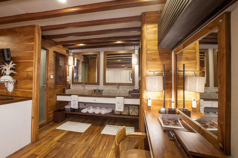 a room with wooden walls and a wood floor aboard PRANA Yacht for Charter