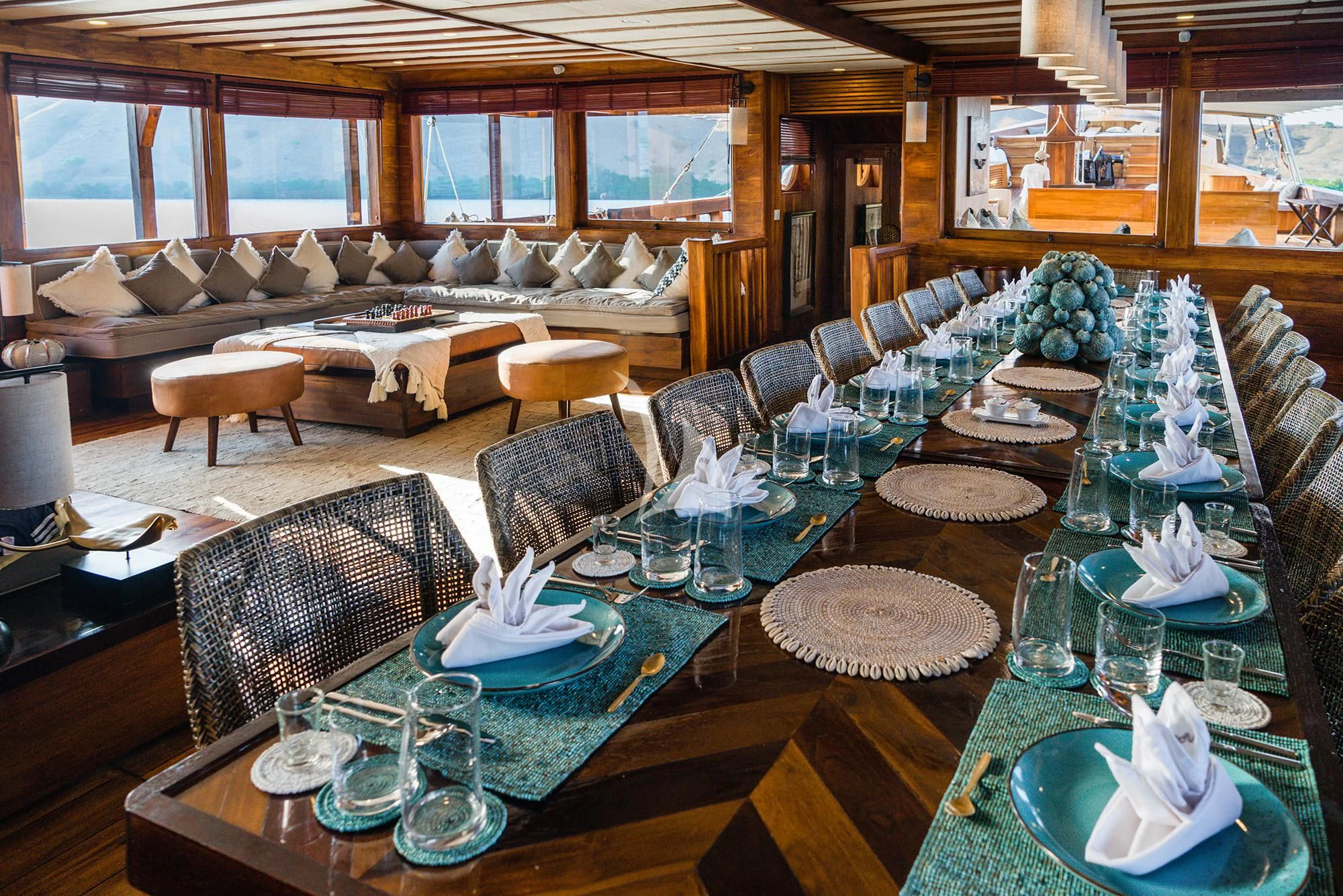 a large room with a table and chairs aboard PRANA Yacht for Charter