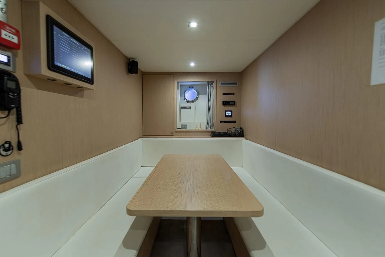 a room with a table and tv aboard NO SAUCE Yacht for Sale