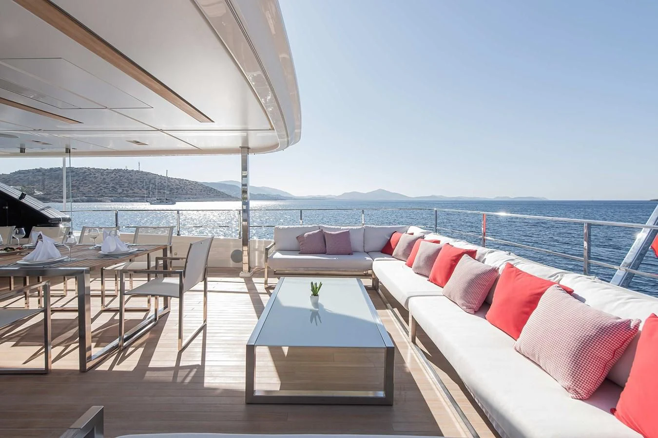 a patio with a table and chairs aboard NO SAUCE Yacht for Sale