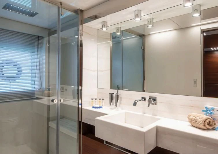a bathroom with a glass shower aboard NO SAUCE Yacht for Sale