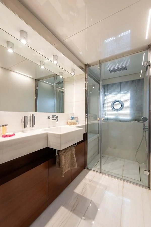 a bathroom with a glass shower aboard NO SAUCE Yacht for Sale