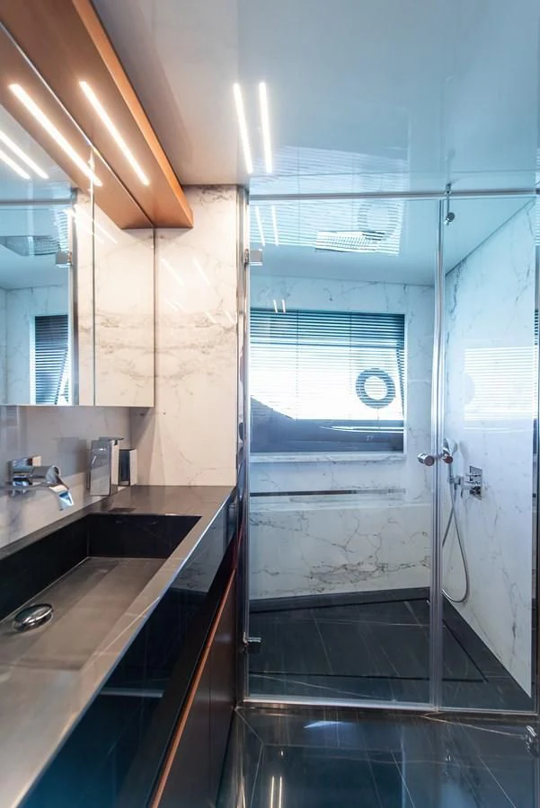 a bathroom with a sink and a shower aboard NO SAUCE Yacht for Sale