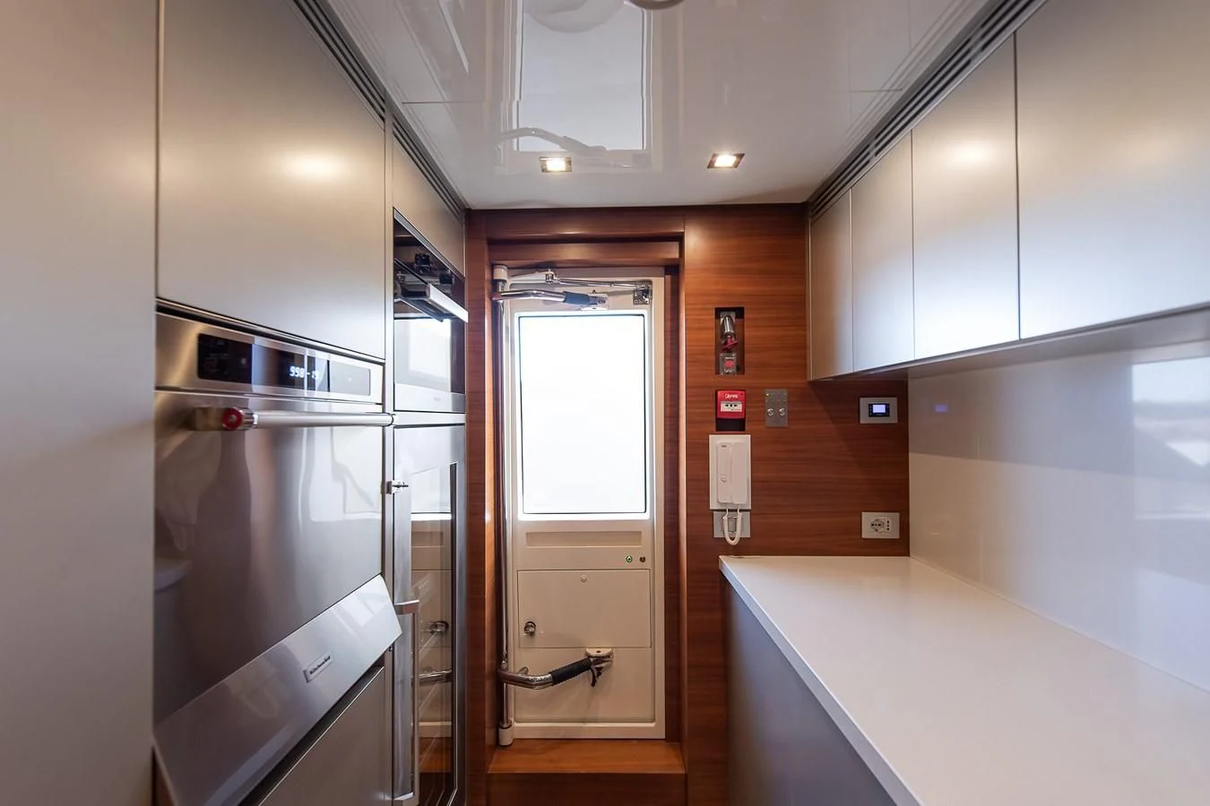 a kitchen with a glass door aboard NO SAUCE Yacht for Sale
