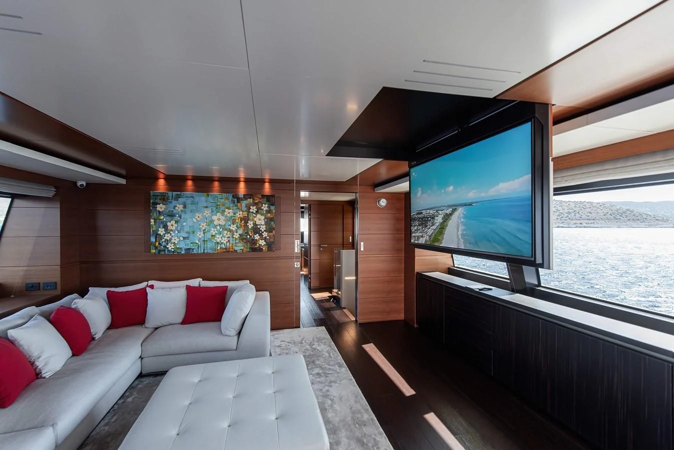 a living room with a large tv aboard NO SAUCE Yacht for Sale