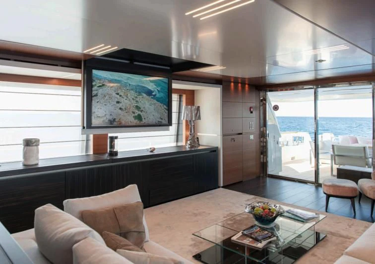 a living room with a large window aboard NO SAUCE Yacht for Sale