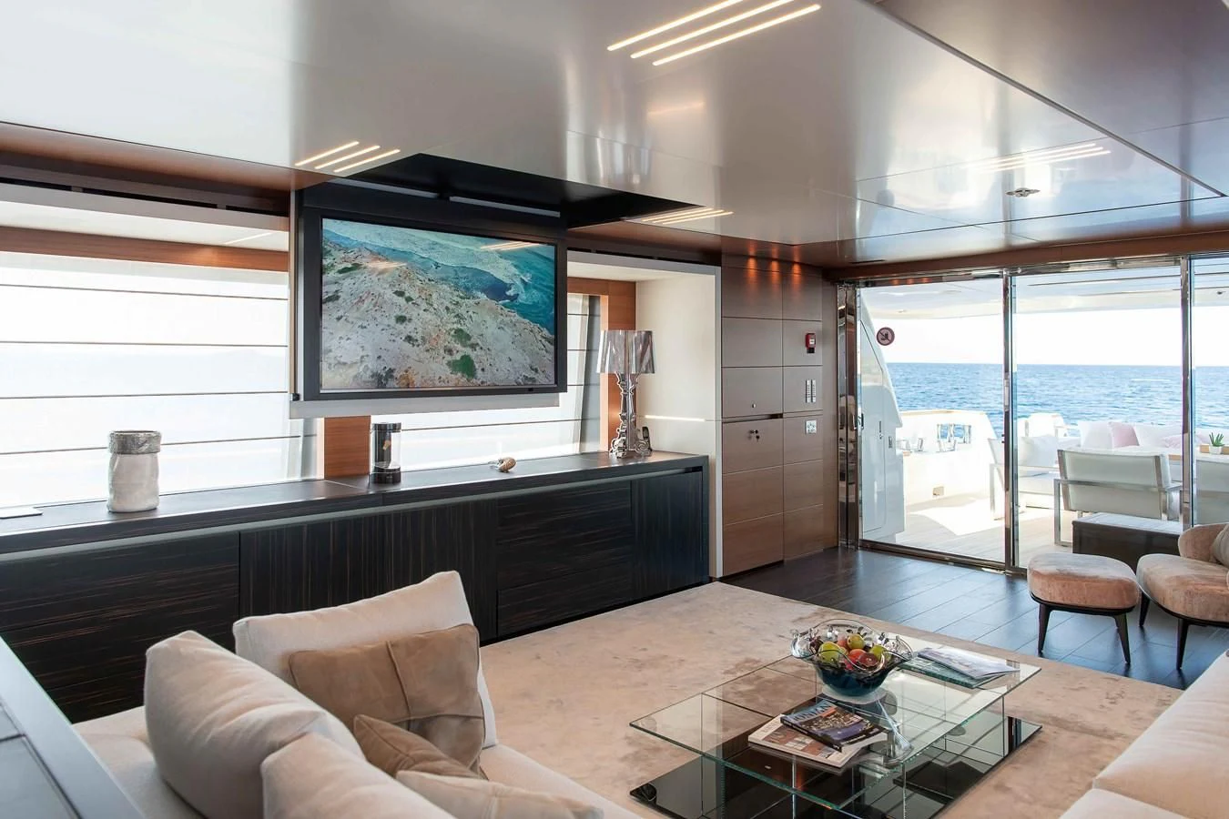 a modern looking living room aboard NO SAUCE Yacht for Sale
