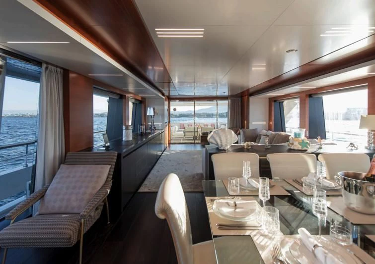 a dining room with a large window aboard NO SAUCE Yacht for Sale