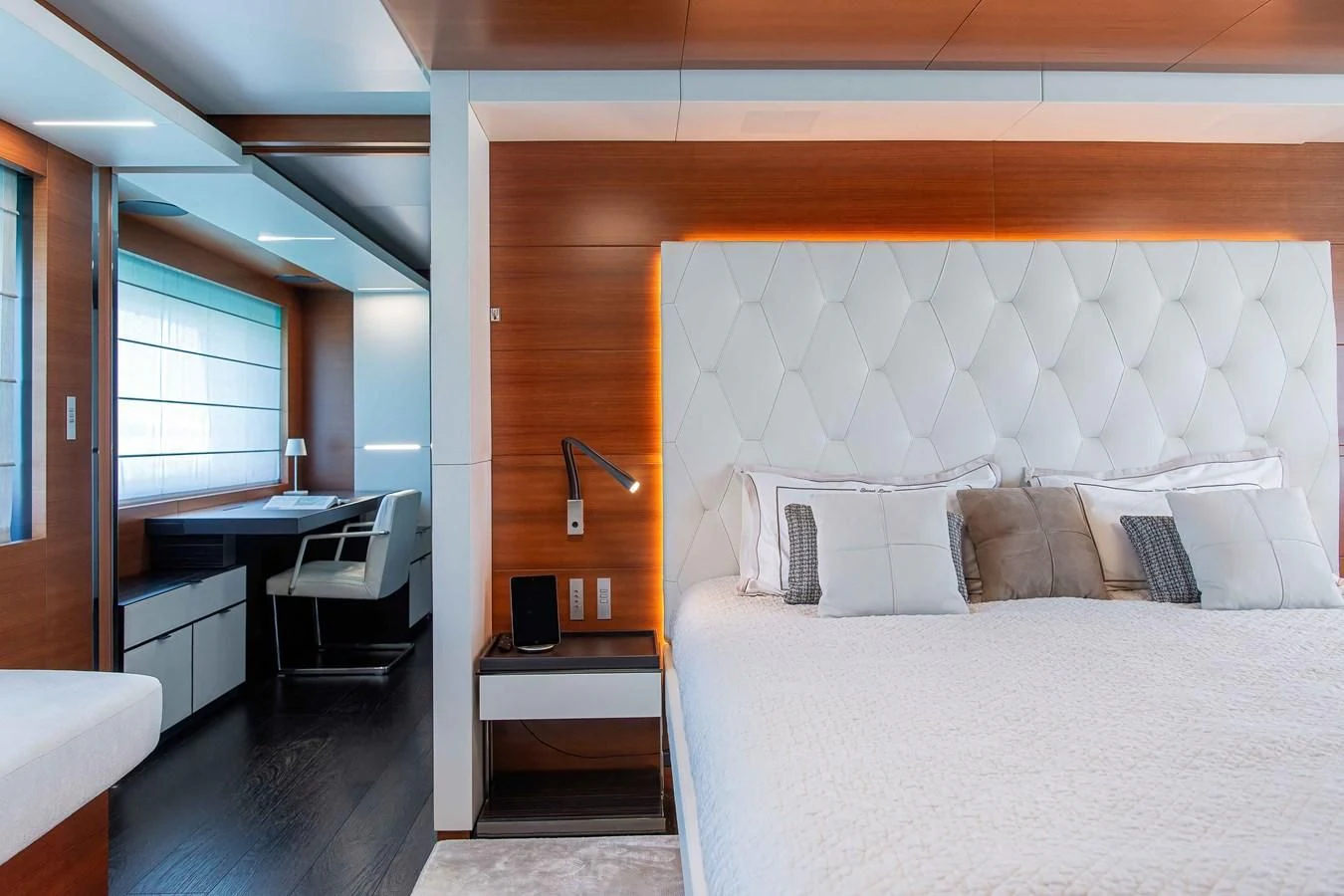 a bedroom with a bed and desk aboard NO SAUCE Yacht for Sale