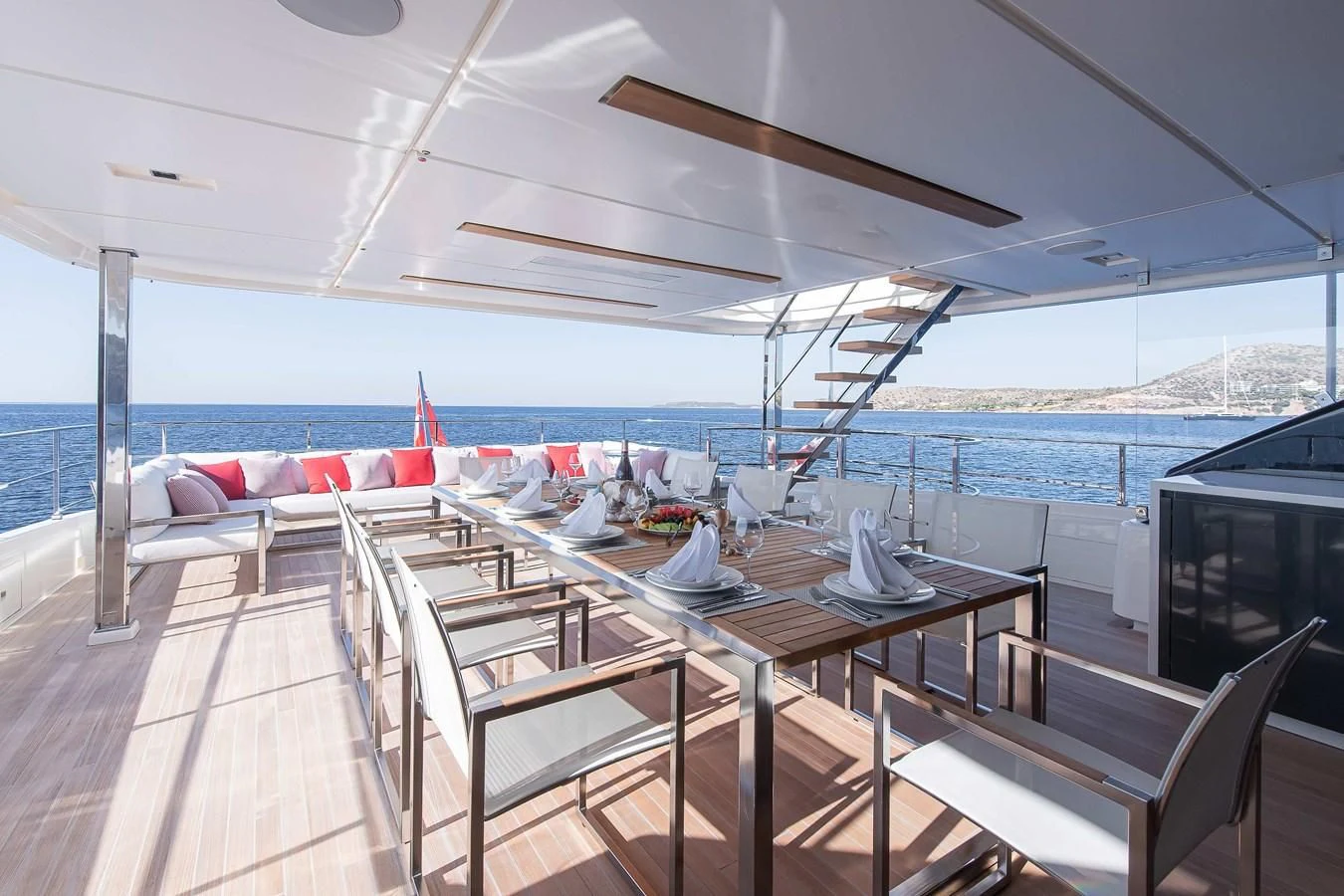 a room with a table and chairs aboard NO SAUCE Yacht for Sale