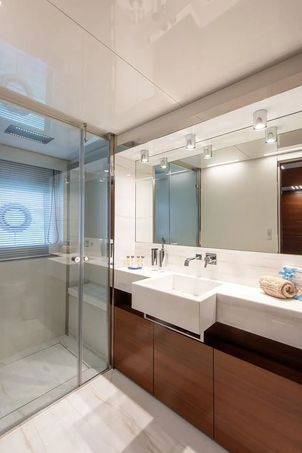 a bathroom with a glass shower aboard NO SAUCE Yacht for Sale