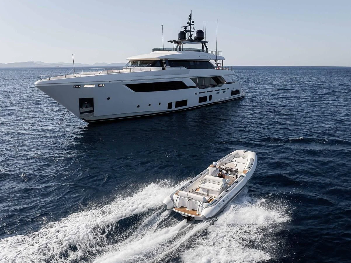 a boat and a motor boat in the water aboard NO SAUCE Yacht for Sale