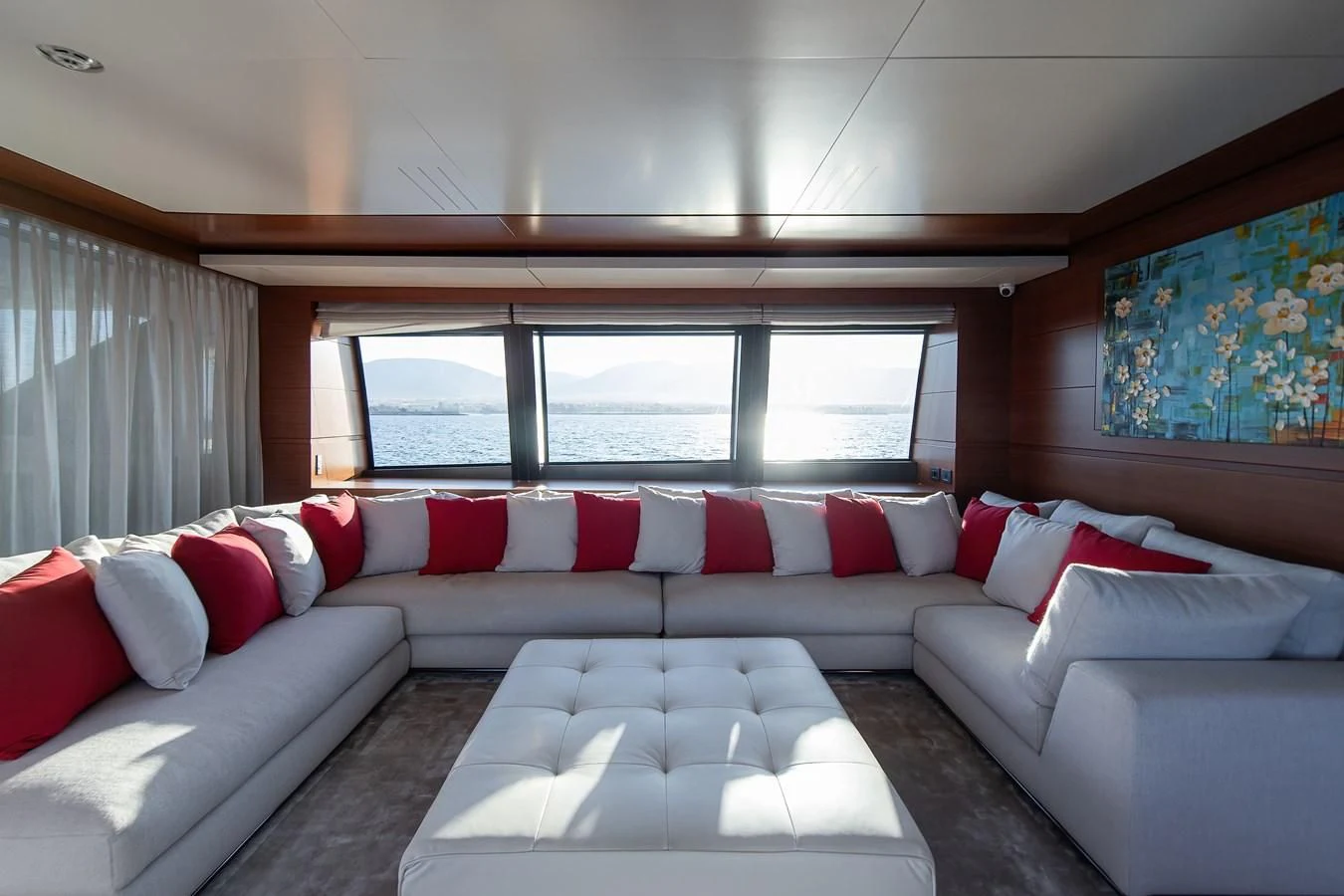 a couch with pillows and a bed aboard NO SAUCE Yacht for Sale