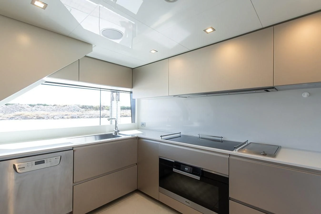 a kitchen with white cabinets aboard NO SAUCE Yacht for Sale