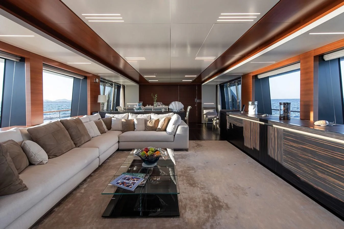 a living room with a couch and a coffee table aboard NO SAUCE Yacht for Sale