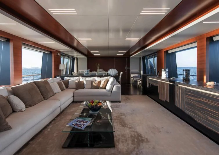 a living room with a couch and a coffee table aboard NO SAUCE Yacht for Sale