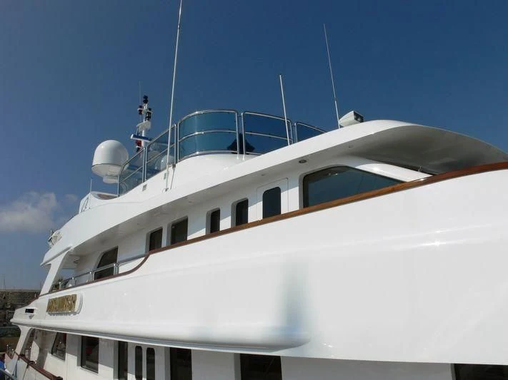 a white boat with a person on top aboard DESAMIS B Yacht for Sale