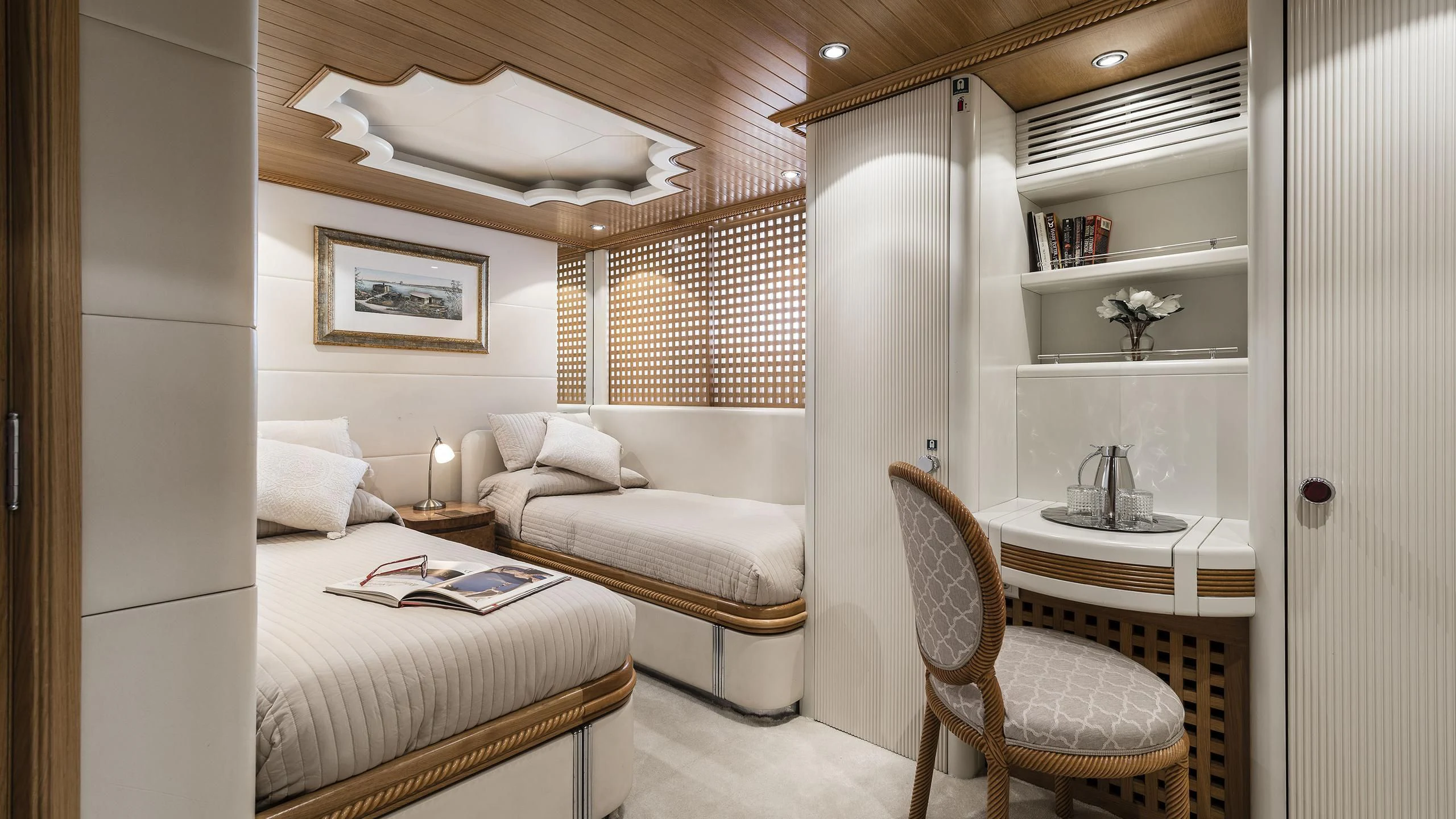 a room with a bed and a chair aboard DESAMIS B Yacht for Sale