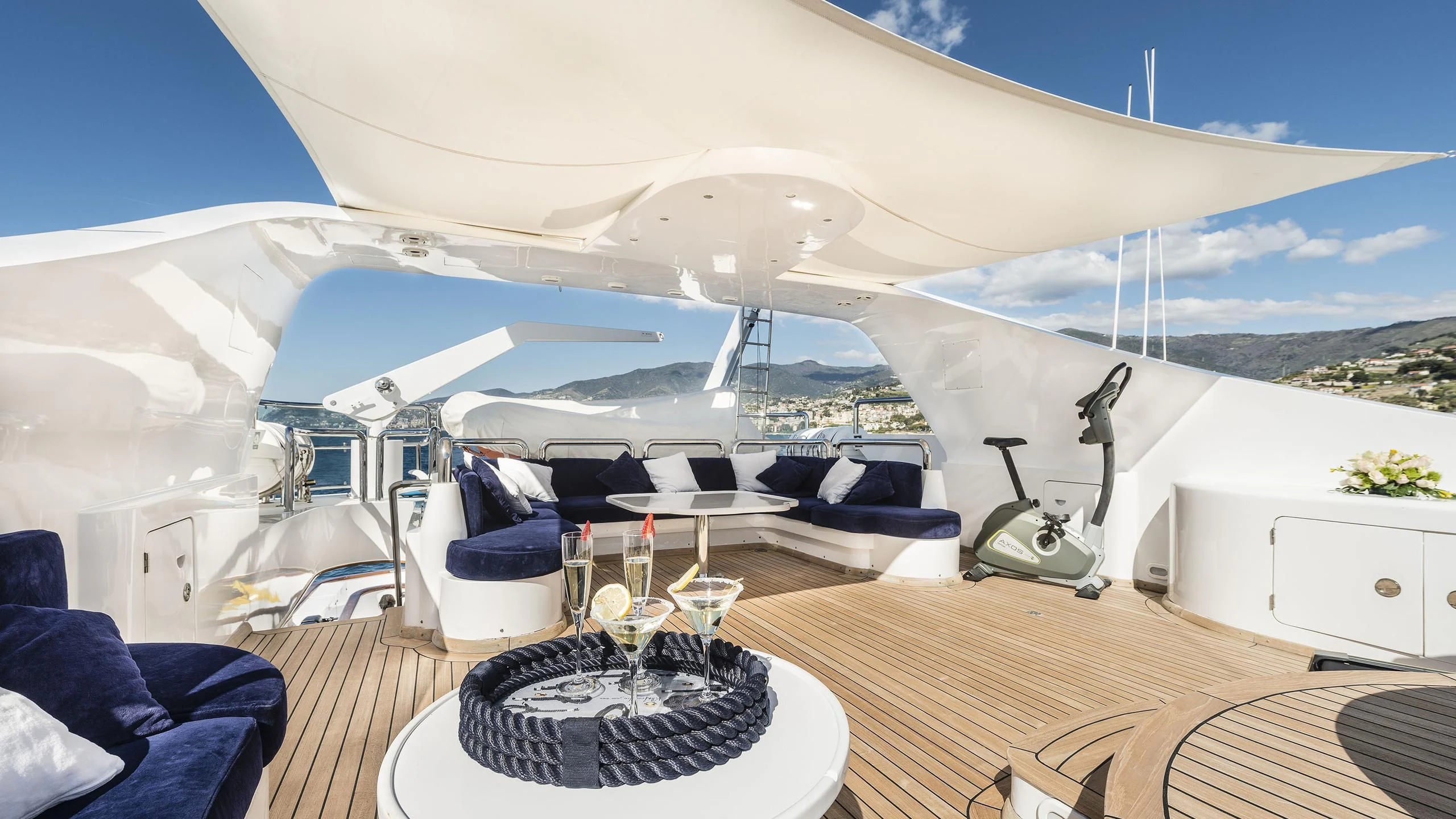 a large white tent with a table and chairs in front of it aboard DESAMIS B Yacht for Sale