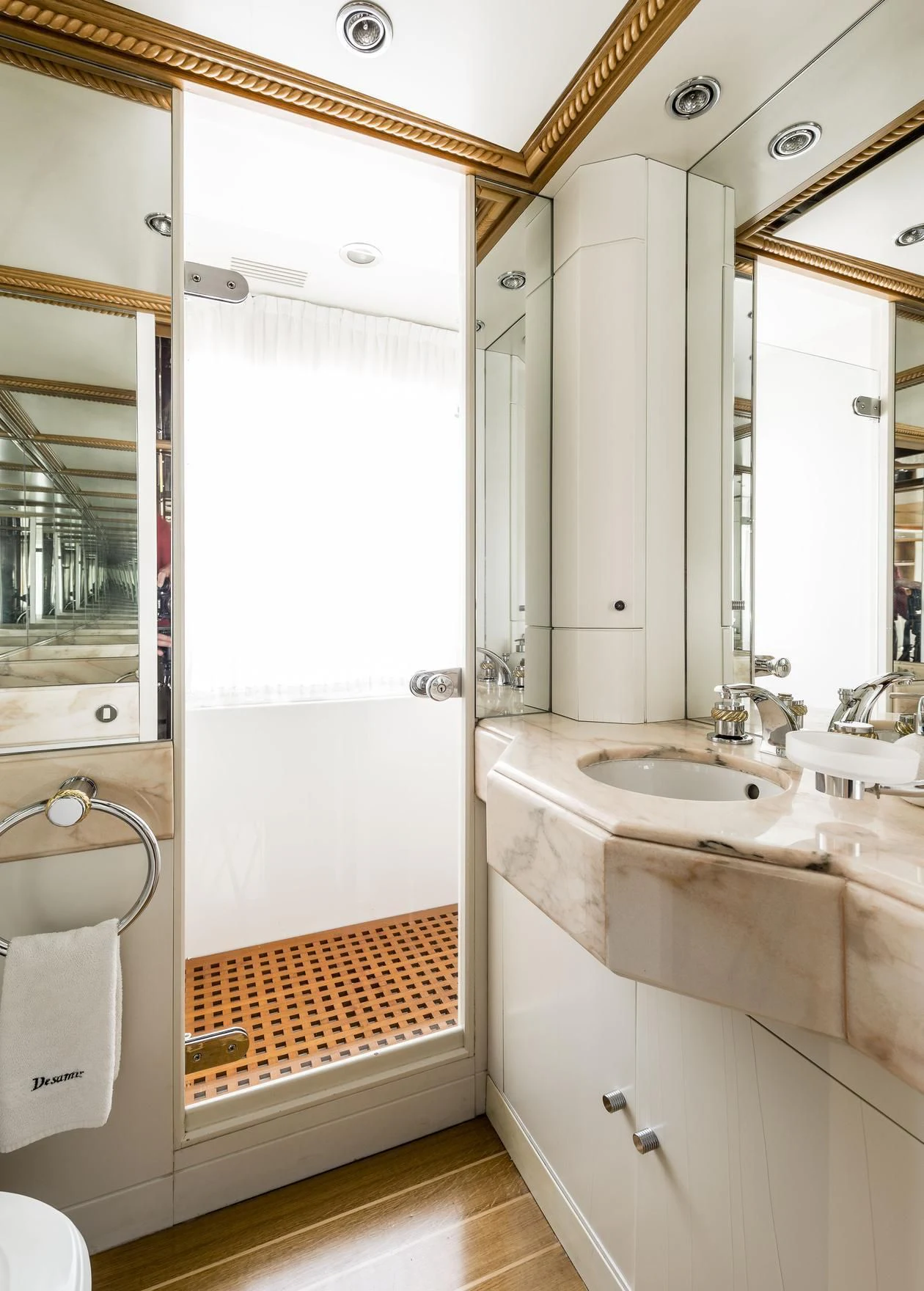 a bathroom with a sink and a mirror aboard DESAMIS B Yacht for Sale