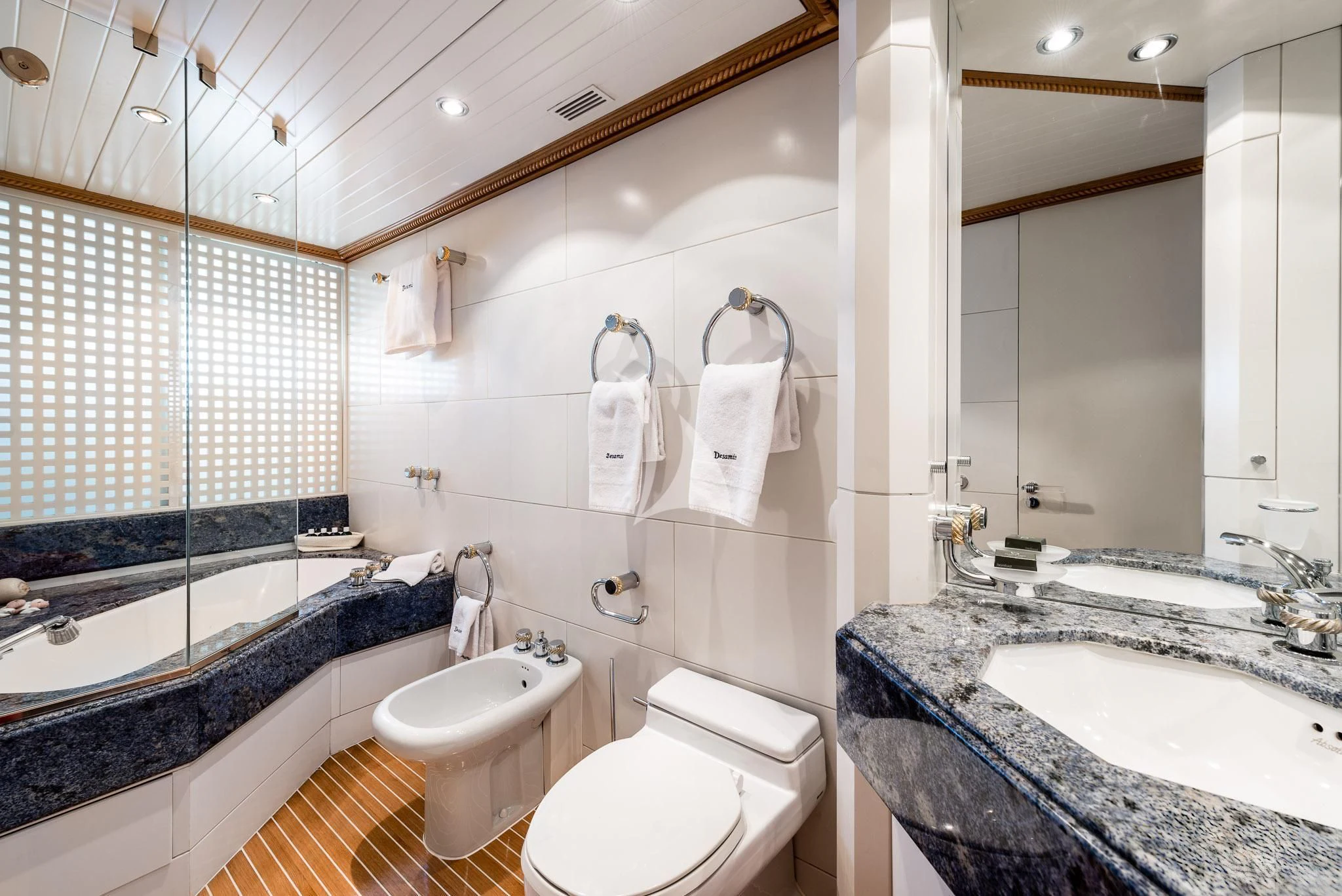 a bathroom with a tub sink and toilet aboard DESAMIS B Yacht for Sale