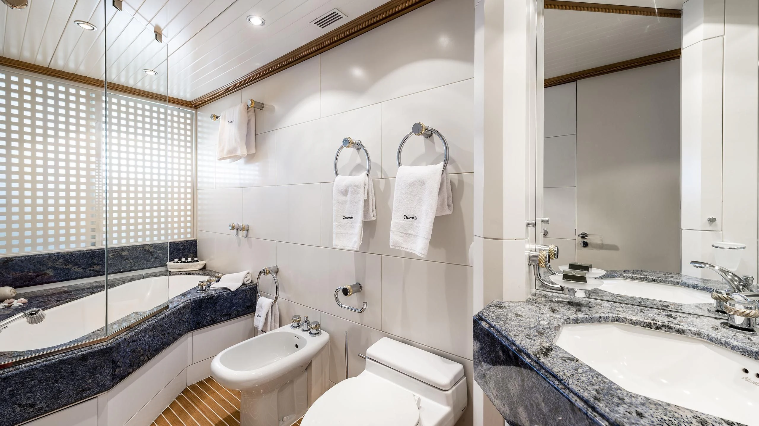 a bathroom with a tub sink and toilet aboard DESAMIS B Yacht for Sale