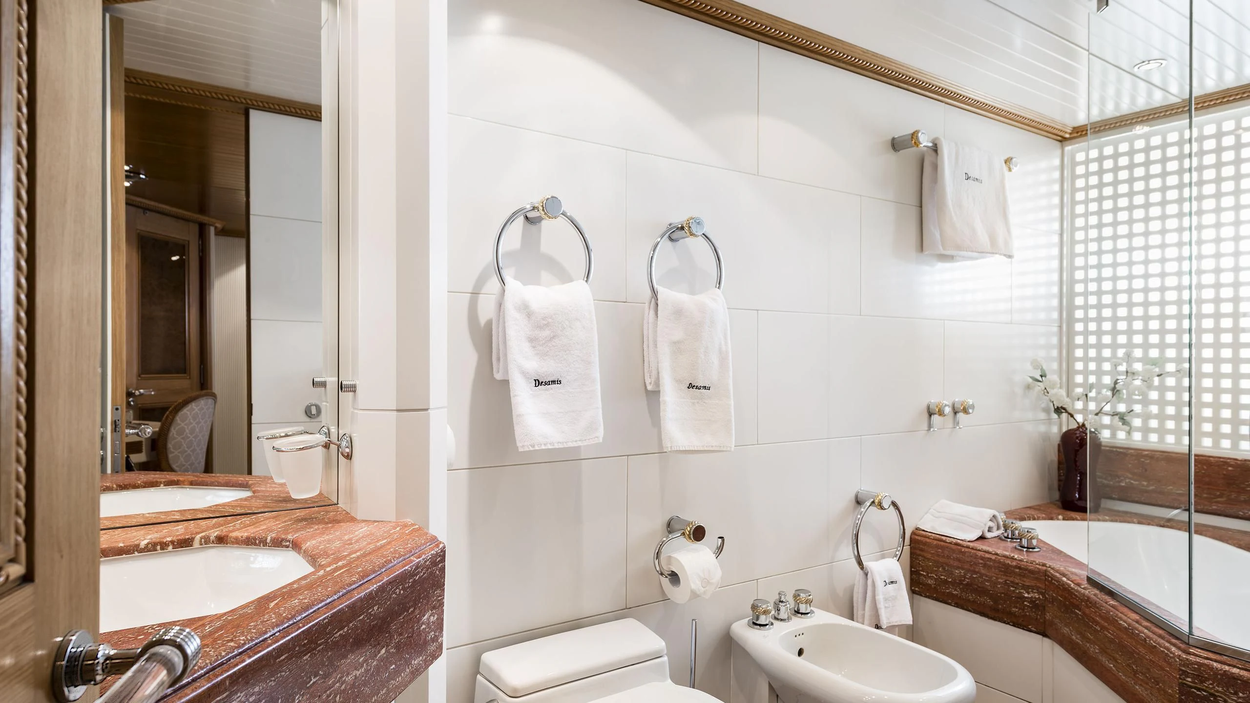 a bathroom with a sink and a mirror aboard DESAMIS B Yacht for Sale