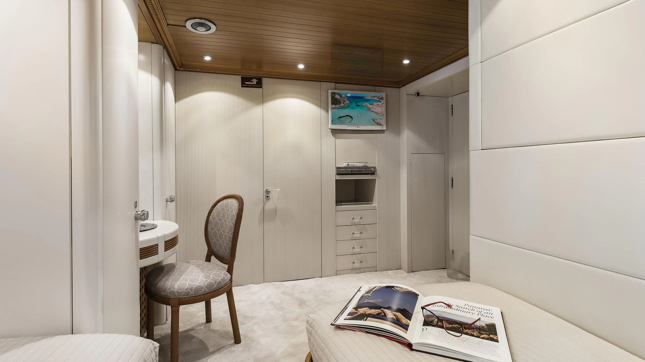 a room with a bed and a chair aboard DESAMIS B Yacht for Sale