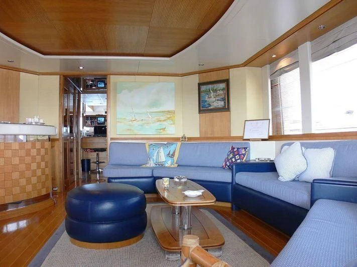 a living room with a blue couch aboard DESAMIS B Yacht for Sale
