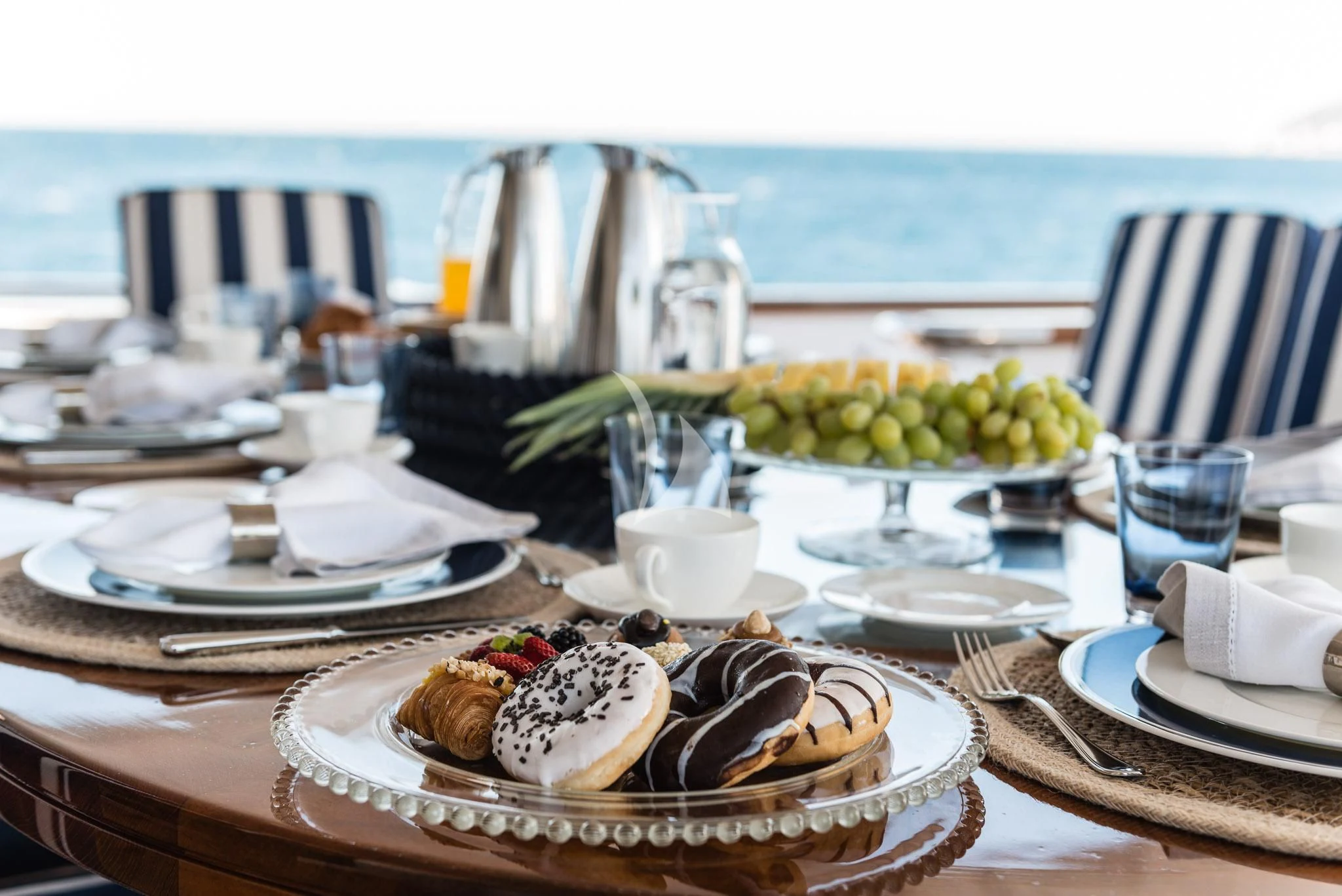 a table with plates and food on it aboard DESAMIS B Yacht for Sale