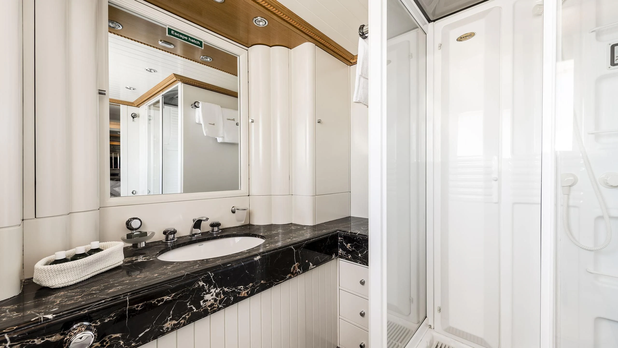 a bathroom with a sink and mirror aboard DESAMIS B Yacht for Sale