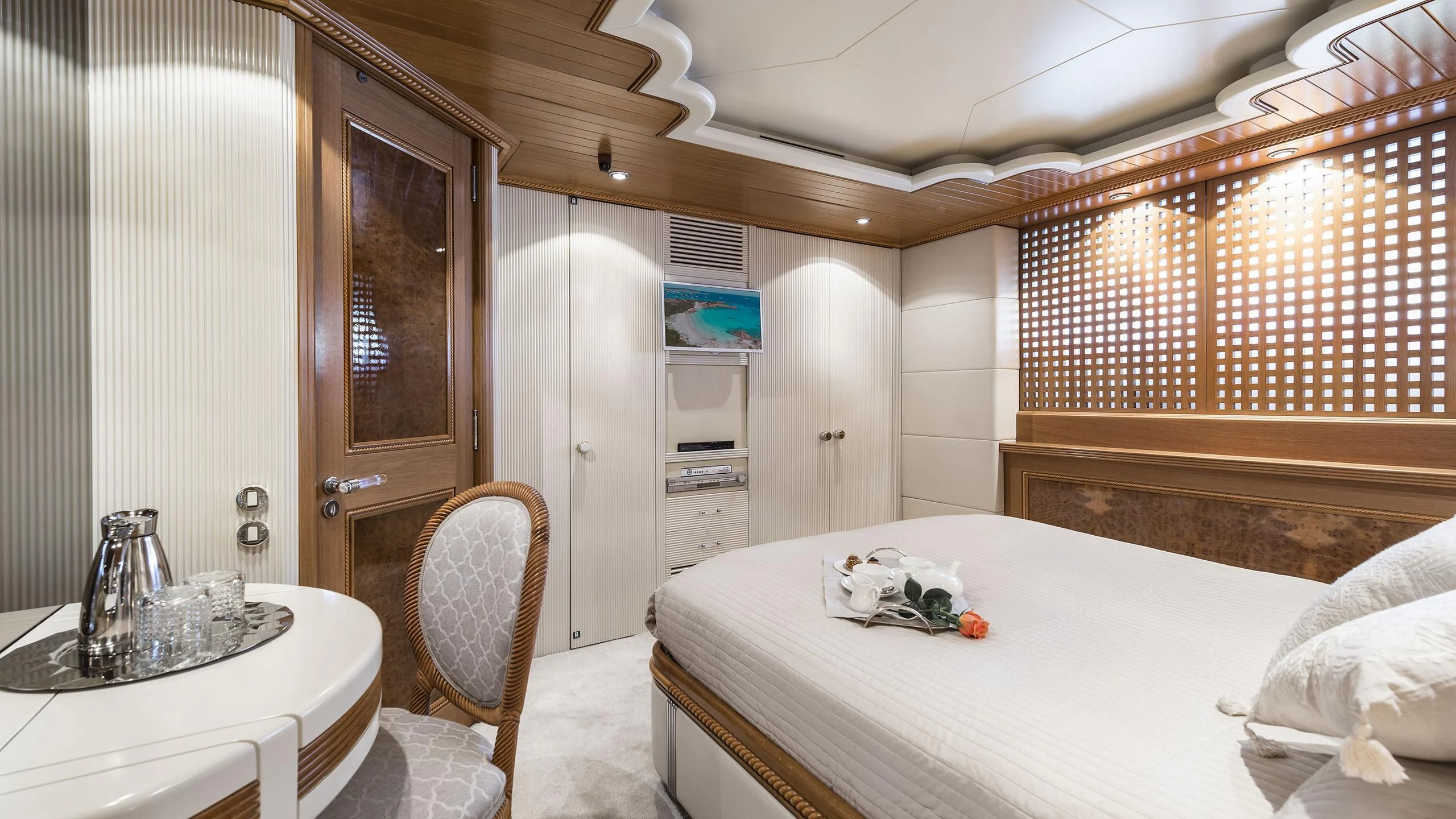 a bedroom with a bed and a table aboard DESAMIS B Yacht for Sale