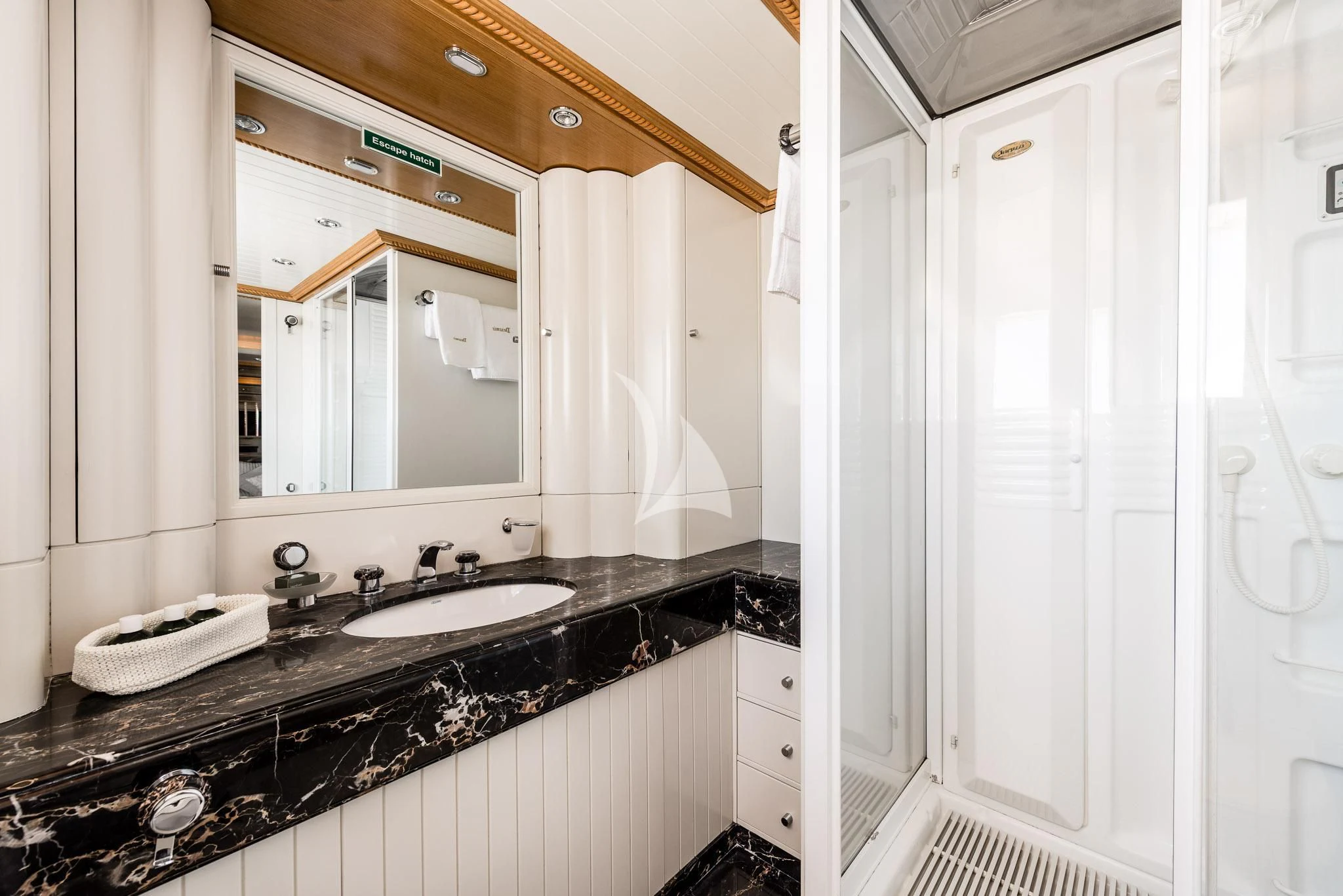 a bathroom with a sink and mirror aboard DESAMIS B Yacht for Sale