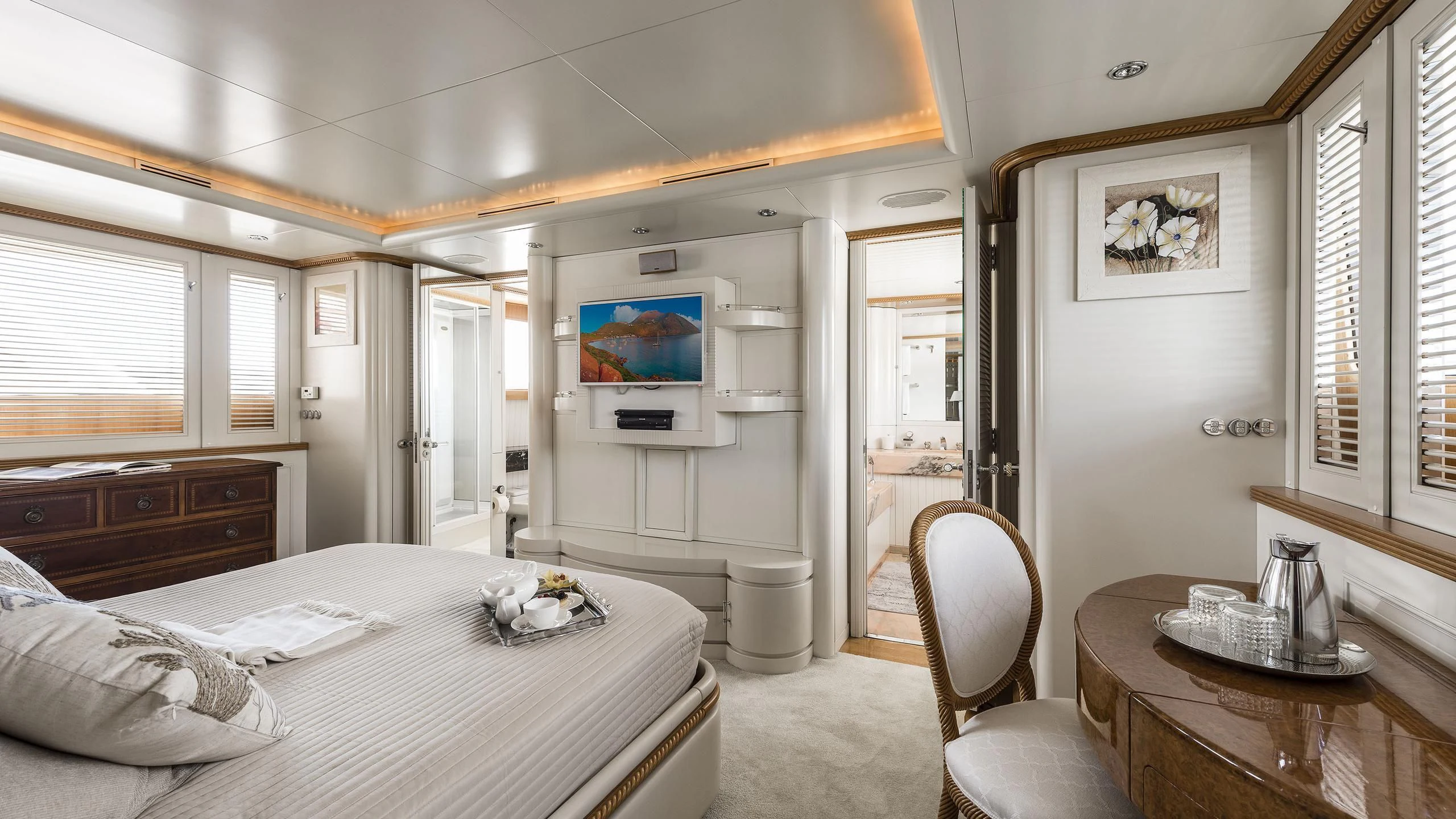 a bedroom with a bed and a television aboard DESAMIS B Yacht for Sale