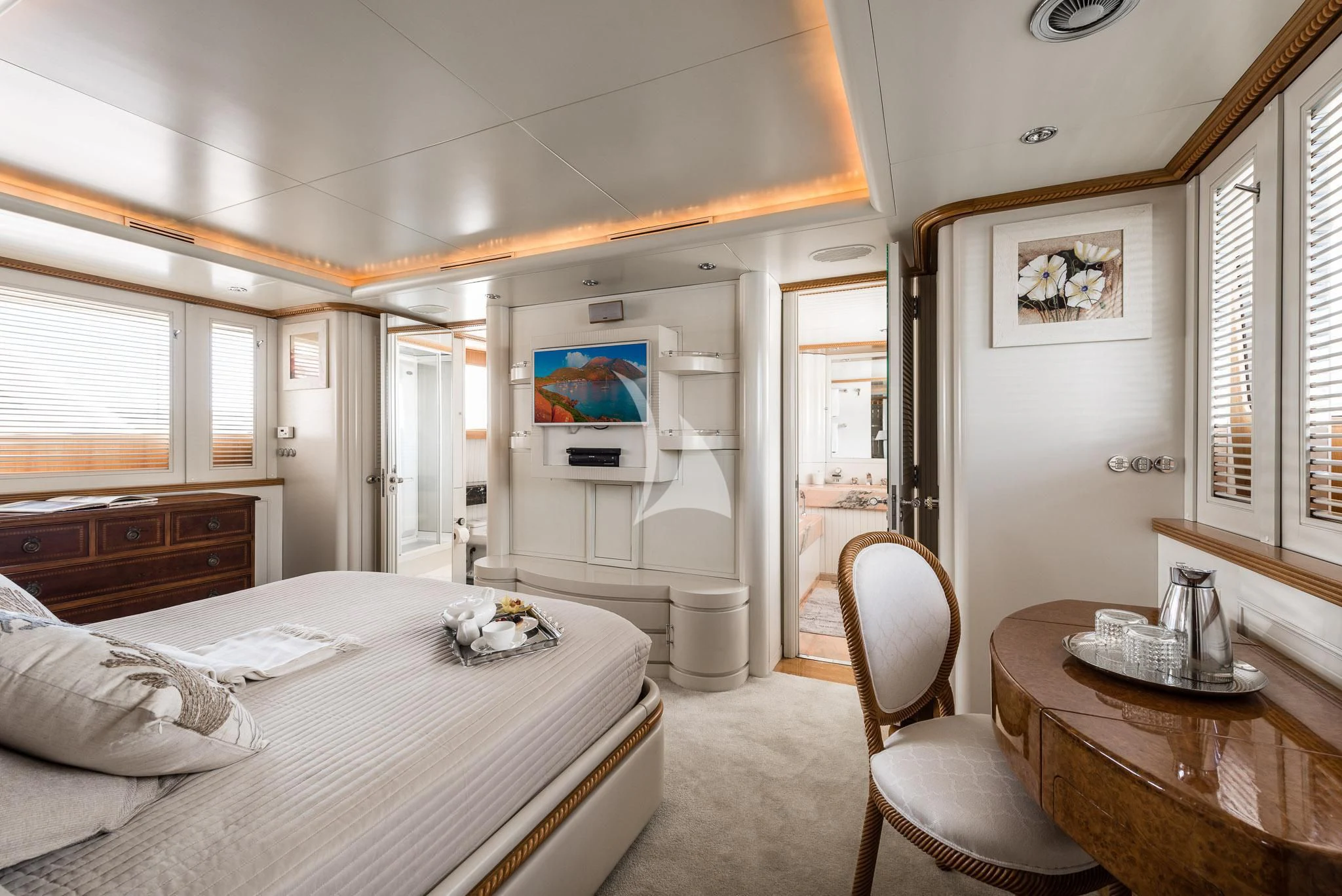 a bedroom with a bed and a table aboard DESAMIS B Yacht for Sale