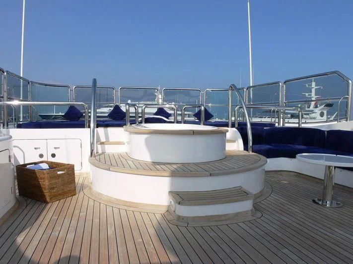 a white bed on a deck aboard DESAMIS B Yacht for Sale