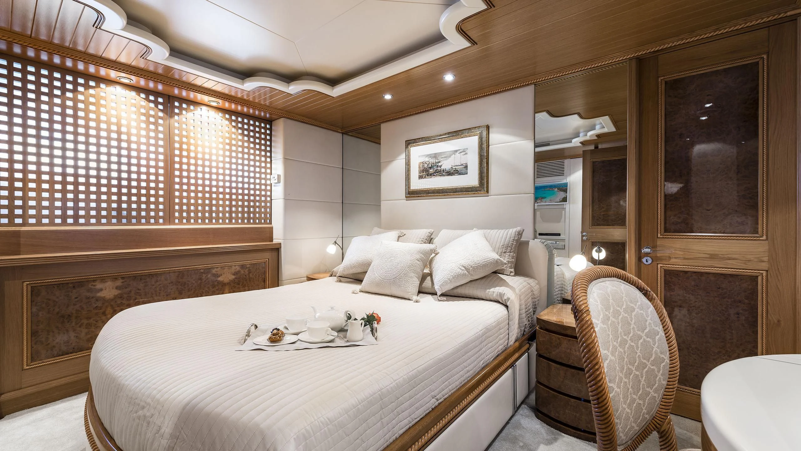 a bed with a white sheet and a brown bed spread aboard DESAMIS B Yacht for Sale