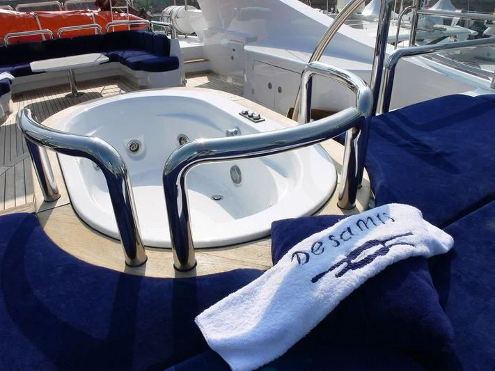 a white chair with a blue seat aboard DESAMIS B Yacht for Sale