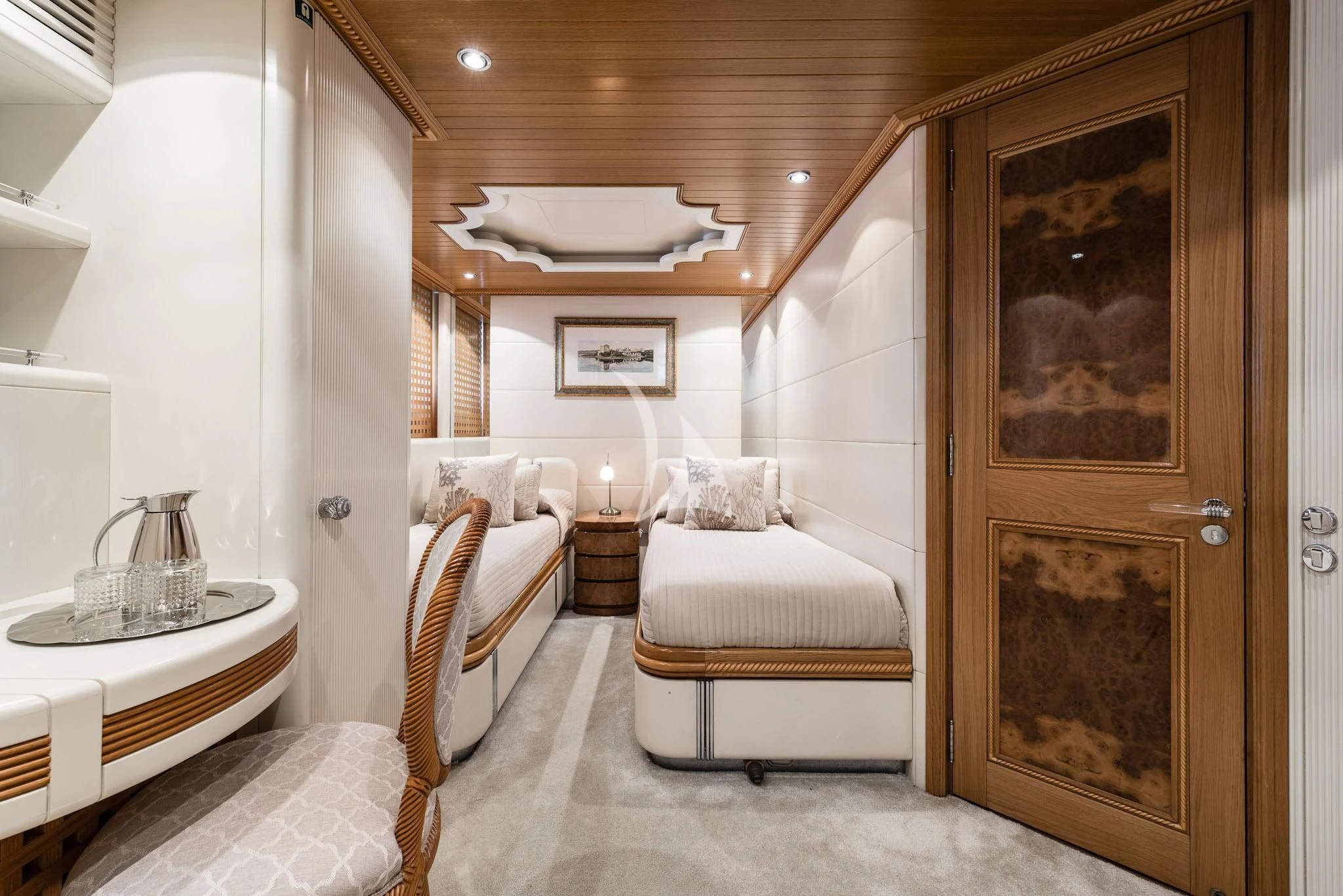 a room with a wood door and a table and chairs aboard DESAMIS B Yacht for Sale