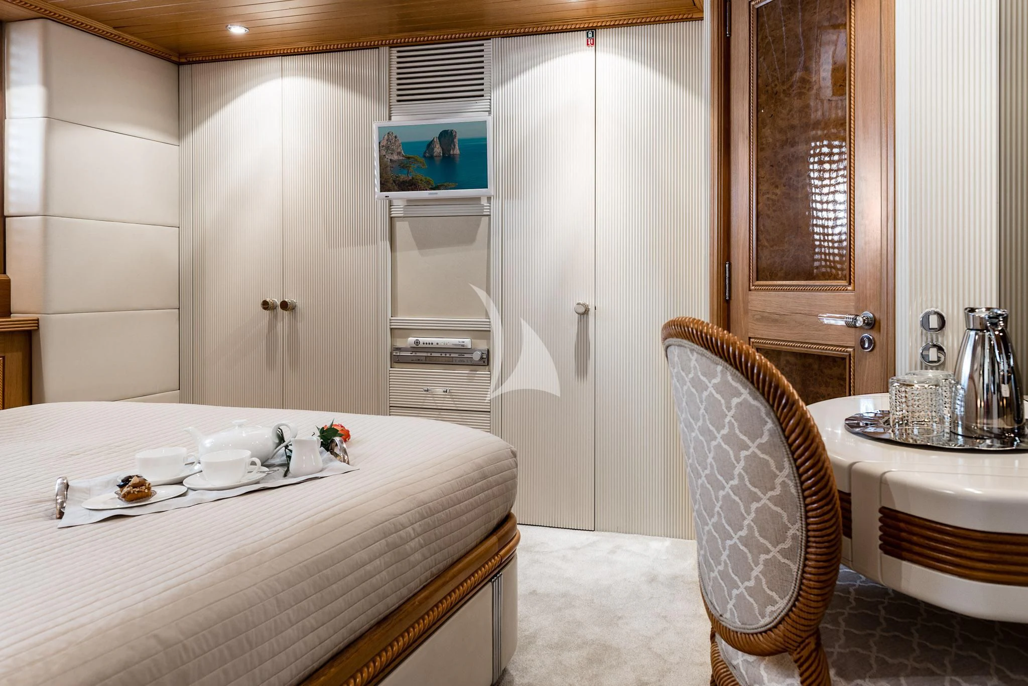 a kitchen with a table and chairs aboard DESAMIS B Yacht for Sale