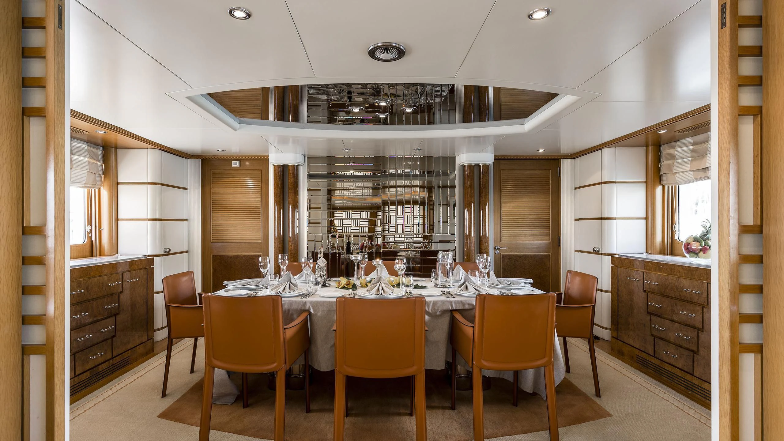 a large kitchen with a table and chairs aboard DESAMIS B Yacht for Sale