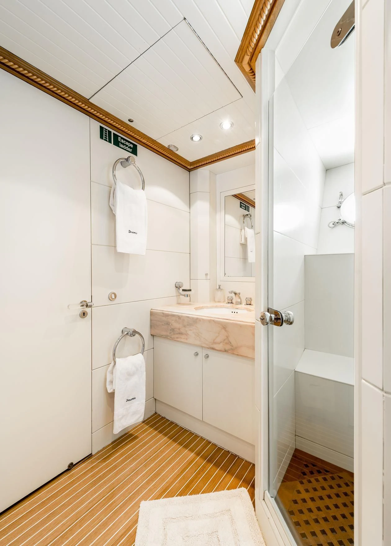 a bathroom with a sink and a mirror aboard DESAMIS B Yacht for Sale