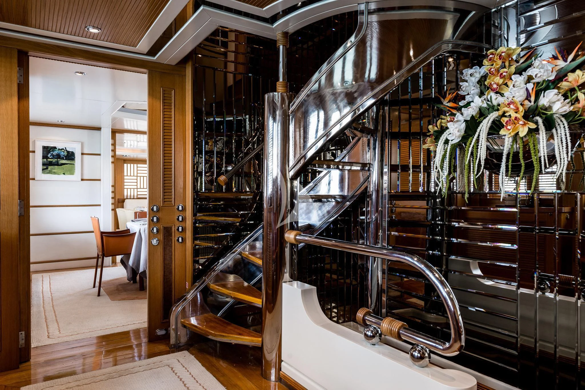 a room with a staircase and chairs aboard DESAMIS B Yacht for Sale