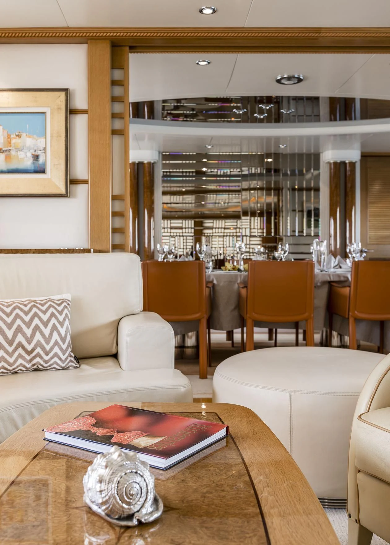 a living room with a table and chairs aboard DESAMIS B Yacht for Sale