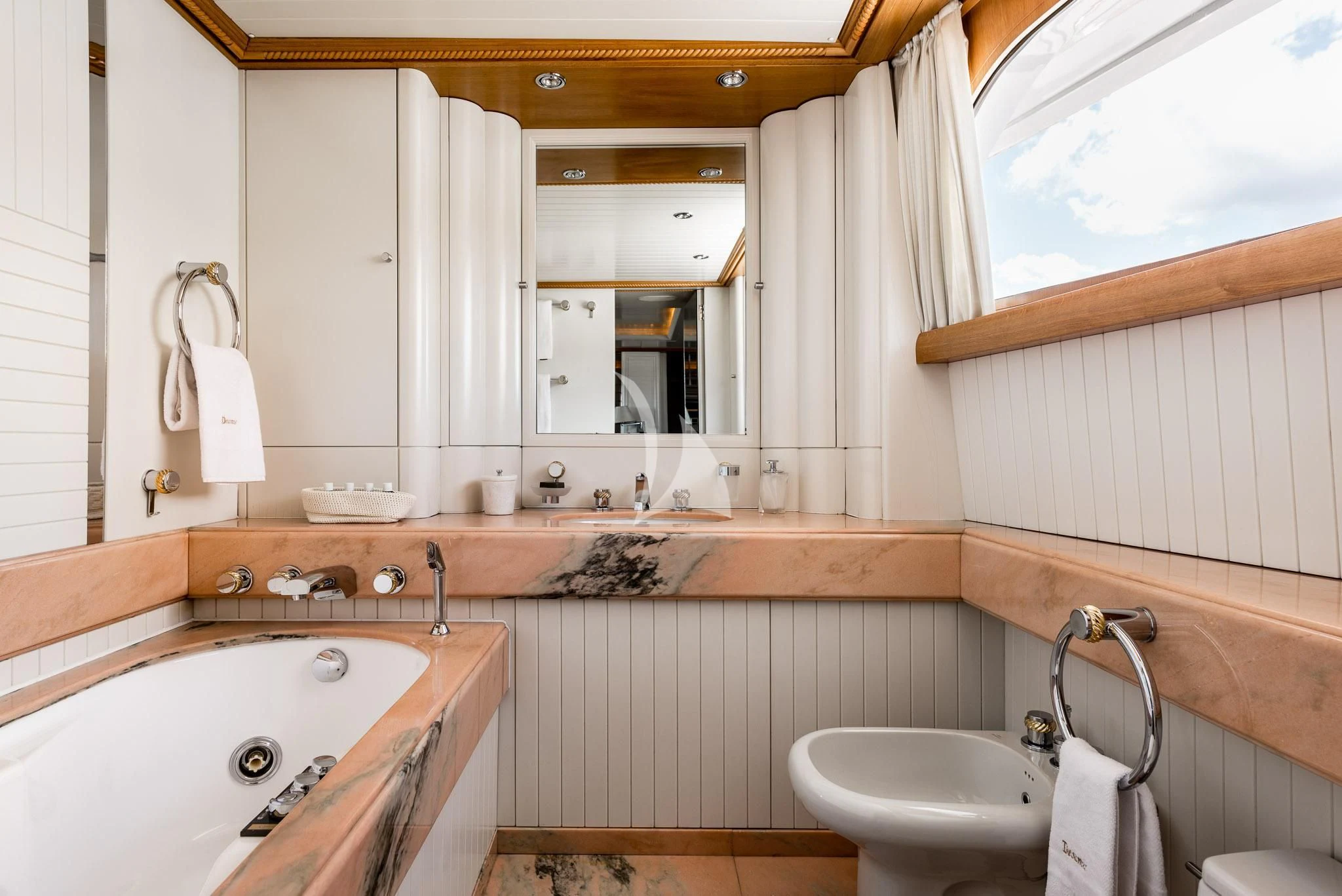 a bathroom with a sink and bathtub aboard DESAMIS B Yacht for Sale
